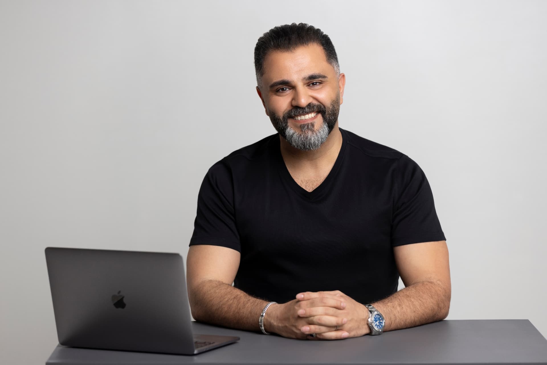Alaa Hassan seated at a desk with a laptop